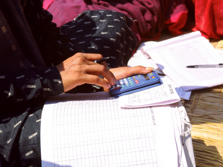 Odell Nepal women banking with calculator