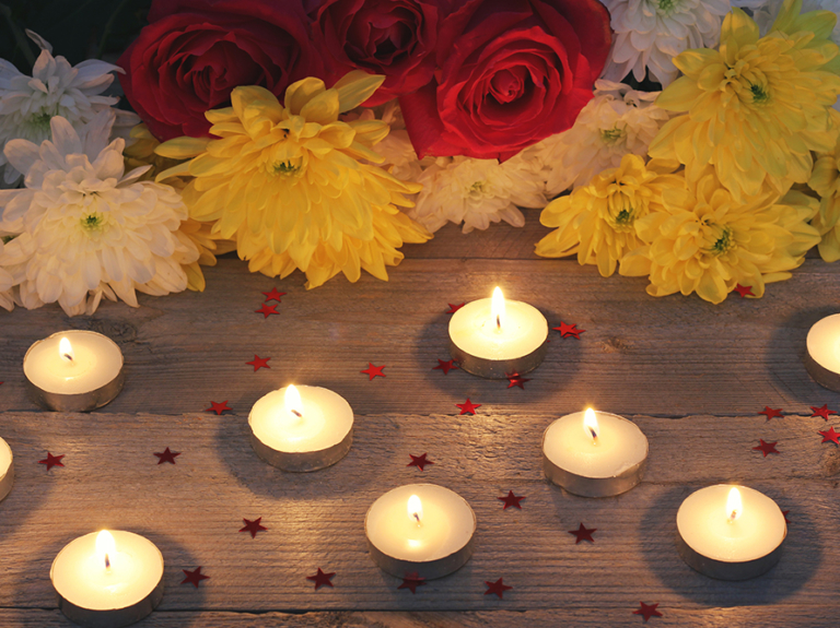 flowers and candles on a wooden platform